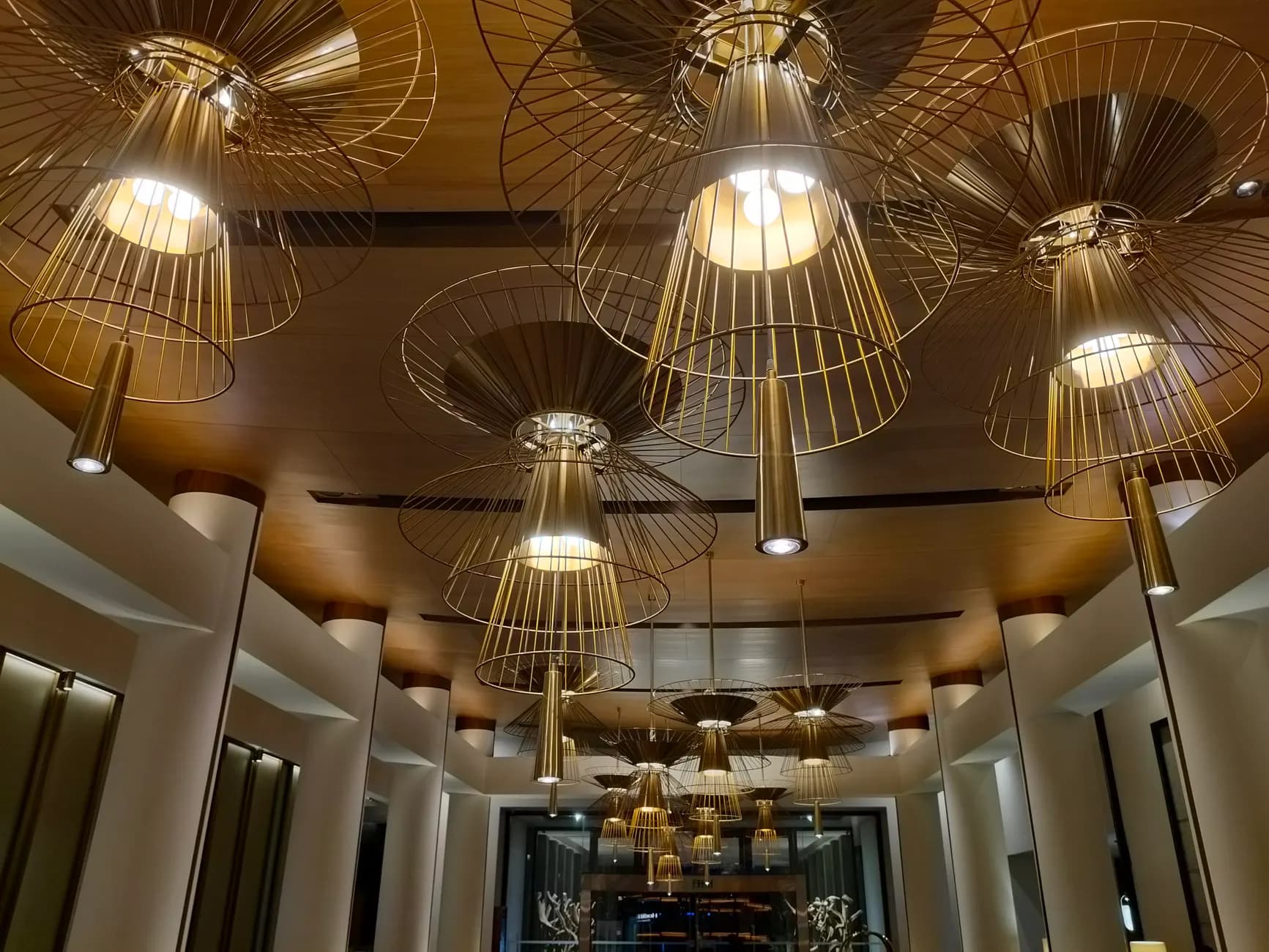 Architectural lobby lighting with geometric fixtures